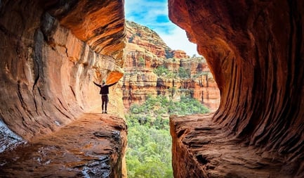Hiker in Arizona surrounded by beautiful red rocks