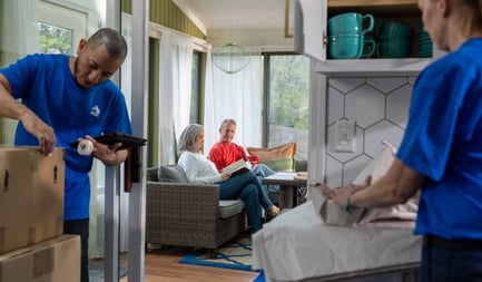 Couple relaxing while Atlas movers pack